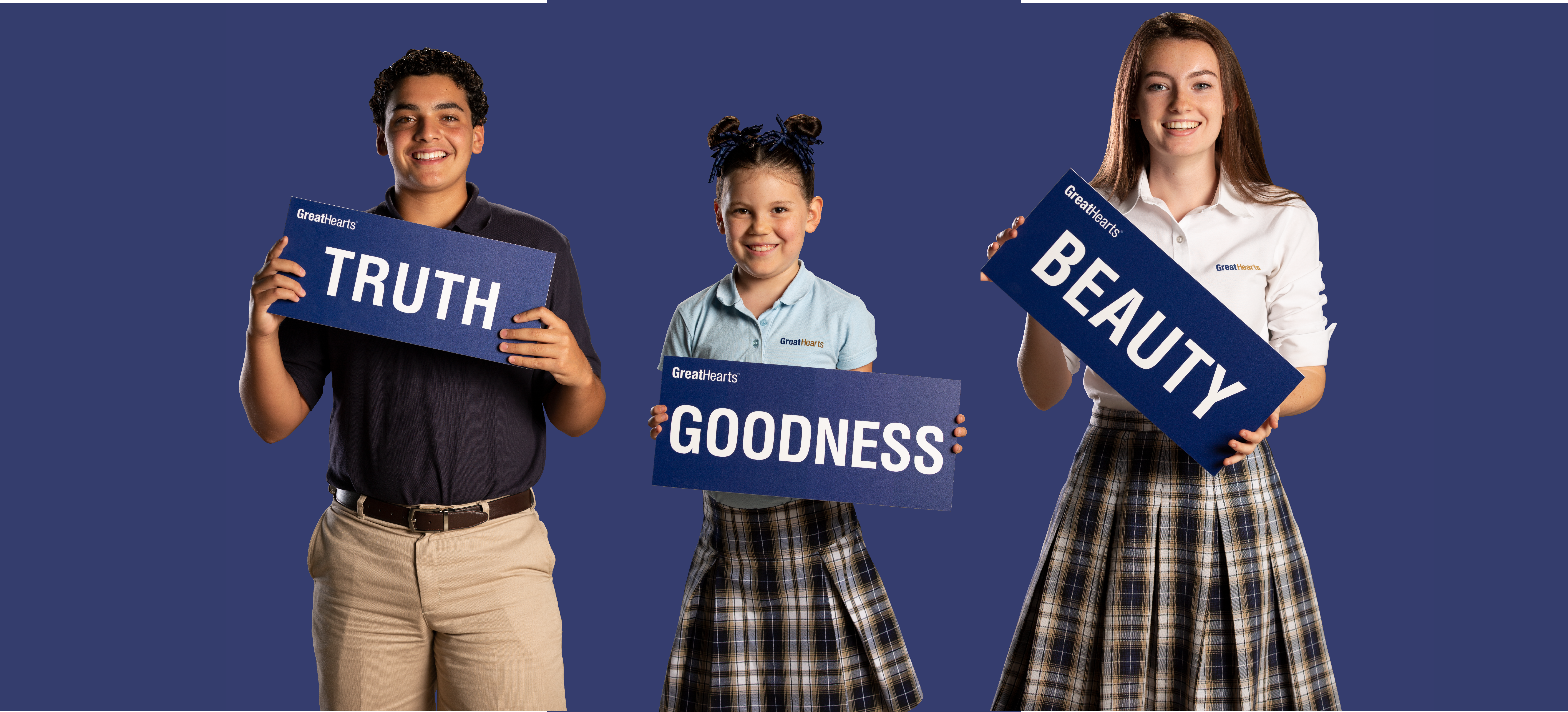 students holding truth goodness and beauty signs